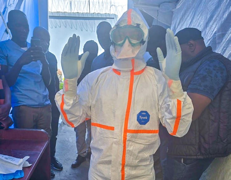 Personal protective equipment donning procedure demonstrated during infection prevention and control training